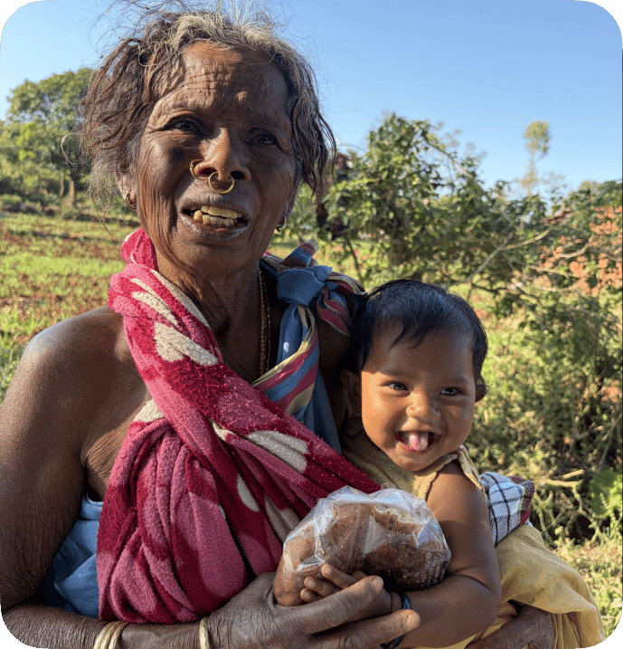A grandmother holding a smiling child